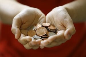 due mani che separano monete dalla fattura