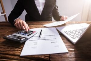 mano che compila fattura su scrivania ordinata