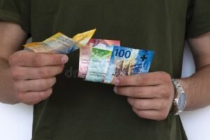 stack di banconote e orologio in mano